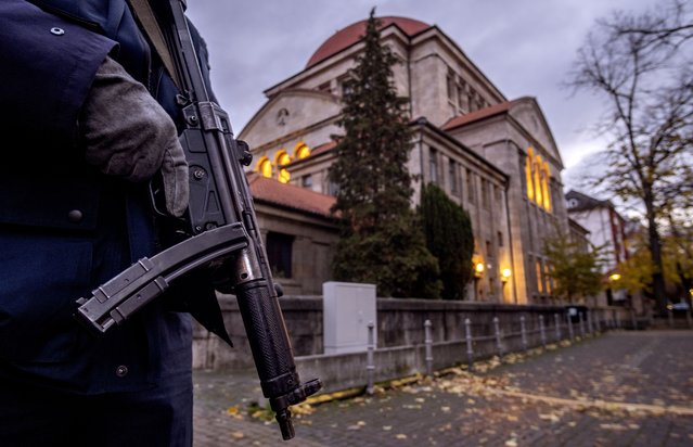 A German police officer stands guard in front of the synagogue in Frankfurt, Germany, early Wednesday, November 8, 2023. A group tracking antisemitism in Germany said Tuesday that it documented a drastic increase of antisemitic incidents in the country in the month after Hamas attacked Israel on Oct. 7. The RIAS group said, it recorded 994 incidents, which is an average of 29 incidents per day and an increase of 320% compared to the same time period in 2022. The group looked at the time period from Oct. 7 to Nov. 9, 2023. (Photo by Michael Probst/AP Photo)