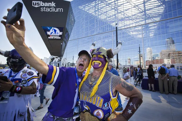 Minnesota Vikings fans Larry Spooner, left, of Plymouth, and Syd Davy, of Vancouver, British Columbia, pose for a photo at the ceremonial grand opening ribbon-cutting for U.S. Bank Stadium in Minneapolis, Friday, July 22, 2016. (Photo by Leila Navidi/Star Tribune via AP Photo)