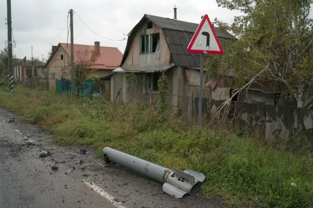 A part of a rocket is seen on the ground in the retaken village of Bohorodychne, eastern Ukraine, Friday, September 23, 2022. (Photo by Leo Correa/AP Photo)
