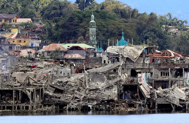 Damaged buildings are seen inside a war-torn area in Marawi City, southern Philippines October 24, 2017, after the Philippines announced on Monday the end of five months of military operations in a southern city held by pro-Islamic State rebels. (Photo by Romeo Ranoco/Reuters)