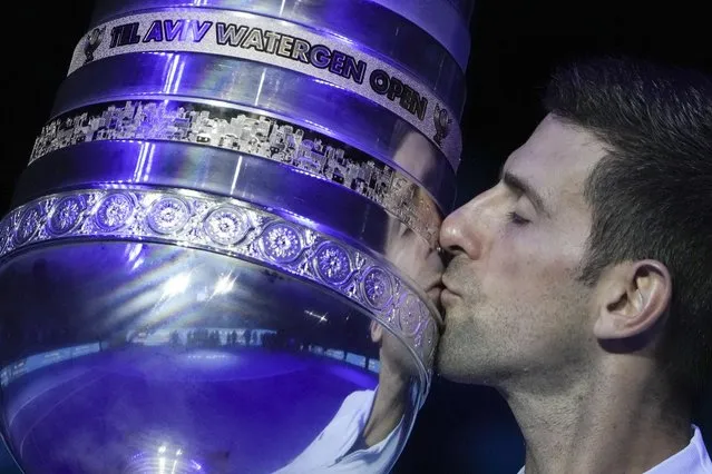 Serbia's Novak Djokovic kisses the trophy after winning the final tennis match of the ATP 250 Tel Aviv open against Croatia's Marin Cilic in Tel Aviv, Israel, Sunday, October 2, 2022. (Photo by Ariel Schalit/AP Photo)
