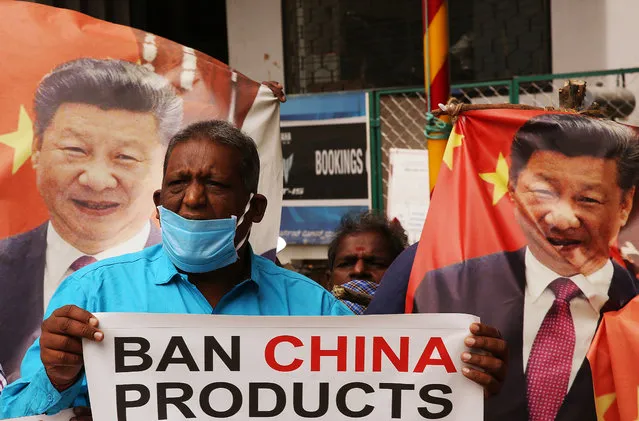Indian activists hold photos of Chinese President Xi Jinping and shouts slogans against China during a protest in Bangalore, India, 18 June 2020. According to media reports, twenty Indian Army personnel including a colonel were killed in the clash with Chinese troops in Galwan Valley of the eastern Ladakh region. (Photo by Jagadeesh N.V./EPA/EFE)