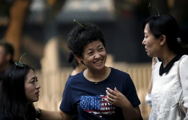 Women wearing sprouts-like hairpins chat on Nanluoguxiang street in Beijing, China, September 16, 2015. (Photo by Kim Kyung-Hoon/Reuters)