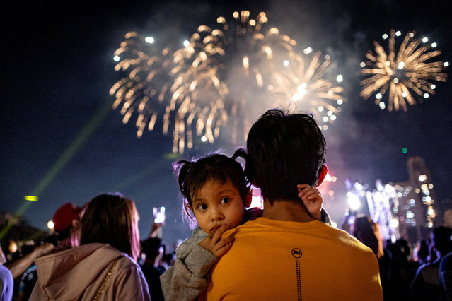 A child looks on as people watch fireworks during Lunar New Year celebrations in Manila, Philippines, on January 29, 2025. (Photo by Eloisa Lopez/Reuters)