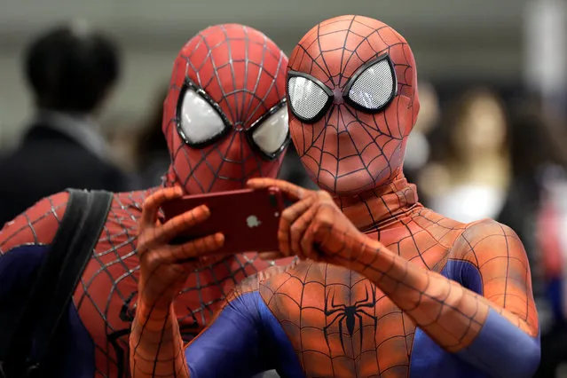 Cosplayers dressed as Spider-Man take a photograph with a smartphone during the Tokyo Comic Convention 2017 at Makuhari Messe in Chiba, east of Tokyo, Japan, 01 December 2017. The event, which runs until 03 December, offers comic fans an enthusiastic experience with exhibitions and displays of Japanese and American pop culture. (Photo by Kiyoshi Ota/EPA/EFE)