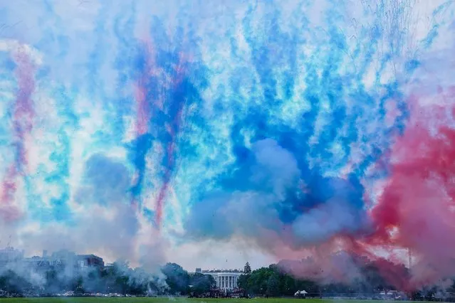 Red and blue smoke is fired at the Ellipse of the White House during the “Salute to America” event held to celebrate Fourth of July Independence Day in Washington, U.S., July 4, 2020. (Photo by Sarah Silbiger/Reuters)