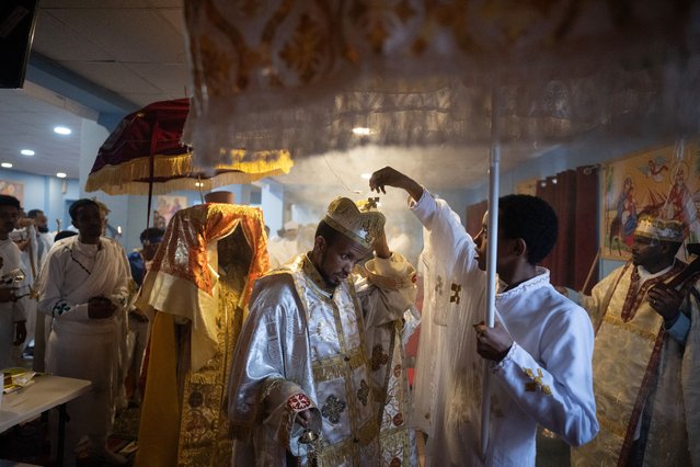 Priests lead a service to celebrate Timket, or the feast of Epiphany, in the Eritrean Orthodox Tewahdo church in Leeds, northern England on January 20, 2024. The Eritrean Orthodox Tewahedo Church's festival of Timket, literally meaning “baptism”, is celebrated on January 19th, or January 20th in a leap year, corresponding to the 11th day of Terr in the Ge'ez calendar. (Photo by Oli Scarff/AFP Photo)
