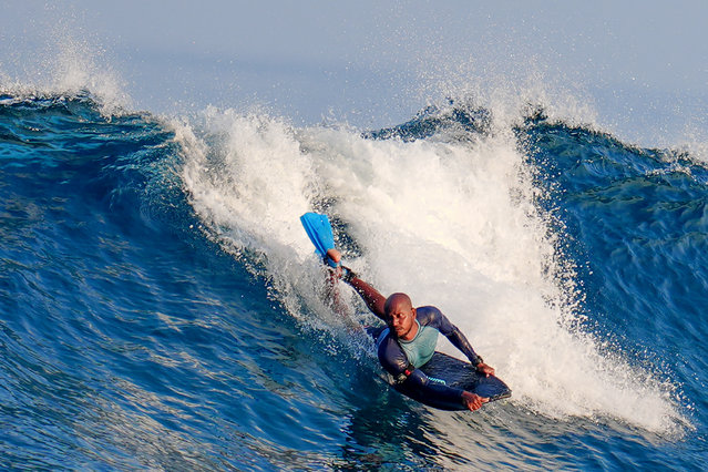 A surfer rides a tidal wave in Male on April 1, 2025. (Photo by Mohamed Afrah/AFP Photo)