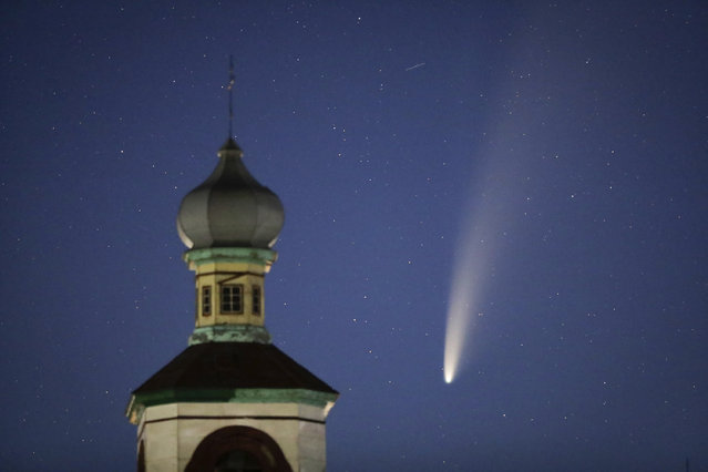 The comet Neowise or C/2020 F3 is seen behind an Orthodox church over the Turets, Belarus, 110 kilometers (69 miles) west of capital Minsk, early Tuesday, July 14, 2020. (Photo by Sergei Grits/AP Photo)