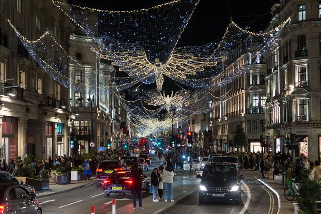 Shoppers walk in Regent Street as the “The Spirit of Christmas” festive lights are switched on in London, United Kingdom on November 09, 2022. (Photo by Wiktor Szymanowicz/Anadolu Agency via Getty Images)