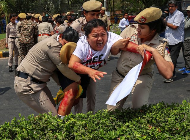 Indian security personnel detain a Tibetan Youth Congress (TYC) activist outside the Chinese Embassy in New Delhi, India, 11 April 2025. TYC members were protesting the alleged sudden and mysterious death of Tulku Hungkar Dorje, a revered Tibetan religious leader, while in custody in Vietnam. The activists called for a transparent and independent investigation into the circumstances of his death and the public release of its findings. (Photo by Rajat Gupta/EPA/EFE)