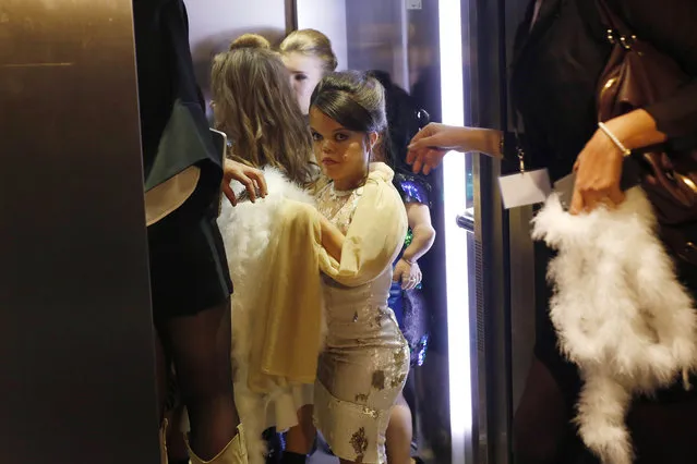 Models get in an elevator moments before hitting the catwalk at the French Ministry of Culture during the dwarf fashion show  in Paris, France, Friday October 2, 2015. (Photo by Jerome Delay/AP Photo)