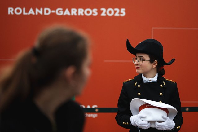 A student of Ecole polytechnique, a science and engineering school in France, wearing school's uniform stands in an alley of the Roland-Garros Complex during the French Open tennis tournament in Paris on May 27, 2025. (Photo by Franck Fife/AFP Photo)