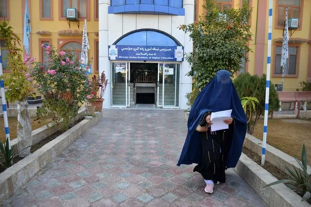 A female university Student walks in front of a university in Kandahar Province on December 21, 2022. Afghanistan's Taliban rulers have banned university education for women nationwide, provoking condemnation from the United States and the United Nations over another assault on human rights. (Photo by AFP Photo/Stringer)
