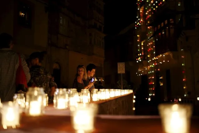 Visitors attend the activity "Birgu by Candlelight" in the medieval city of Birgu, also known as Vittoriosa, outside Valletta, Malta, October 10, 2015. (Photo by Darrin Zammit Lupi/Reuters)