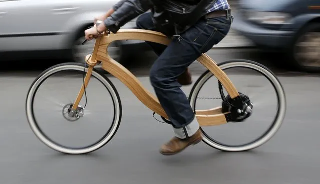 Matthias Broda, inventor and designer of the wooden e-bike, cycles a prototype along a street in Berlin, November 20, 2014. The wooden e-bike produced by German company Aceteam from ash wood, will be launched on the market by spring 2015 and will cost around 3,950 euro (4,950 dollars). The e-bike will be equipped with an 250W e-bike motor for a range of up to 100 kilometer  (62 miles) with a rechargeable battery. (Photo by Fabrizio Bensch/Reuters)