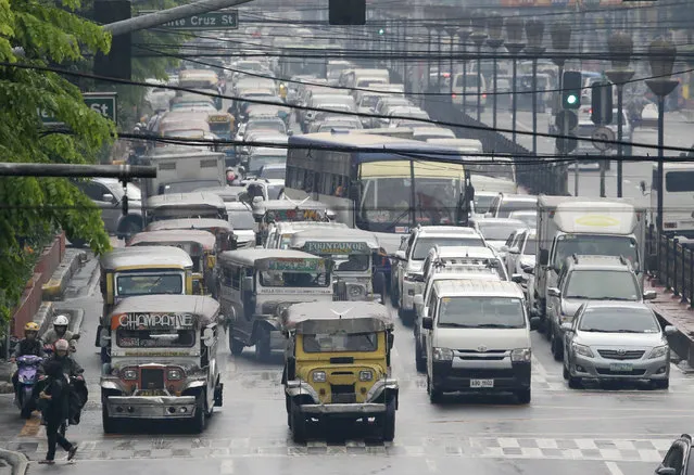 In this October 6, 2017, photo, passenger jeepneys line up along Manila's streets during rush hour traffic in Manila, Philippines. (Photo by Aaron Favila/AP Photo)