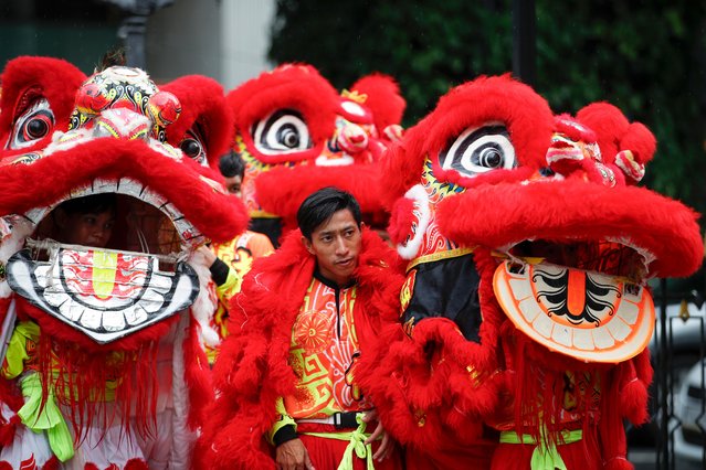 Thai lion dance troupe performers, hired by foreign devotees, prepare to perform a lion dance to worship a statue of Lord Brahma, the Hindu god of creation, during a worship session after their prayers were fulfilled at the Erawan Shrine in Bangkok, Thailand, 21 May 2025. The Erawan Shrine houses a golden statue of Lord Brahma, the Hindu god of creation. Built and blessed in 1956, the shrine is popular among both Thai and foreign tourists. Most devotees, primarily of Chinese origin, visit to offer prayers and hire Thai traditional dancers to perform worship rituals in gratitude after their wishes are fulfilled. (Photo by Rungroj Yongrit/EPA/EFE)