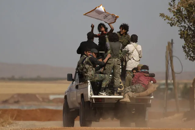 Harakat Nour al-Din al-Zenki fighters ride on a pick-up truck in the northern Syrian rebel-controlled town of al-Rai, in Aleppo Governorate, Syria, September 27, 2016. (Photo by Khalil Ashawi/Reuters)