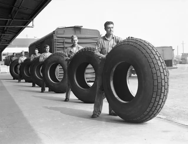 Soldier volunteer tire workers line up with some of the huge bomber tires made at the U.S. Rubber Company plant in Los Angeles, Calif., February 24, 1945. The need for these tires is so great that overseas veterans were quick to volunteer for work at the plant on furlough time granted to them by the U.S. Army. They are paid regular salaries in addition to Army pay. (Photo by AP Photo)