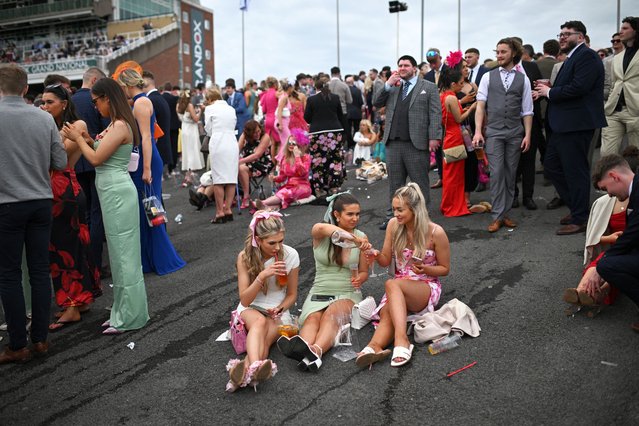 Racegoers attend the second day of the Grand National Festival horse race meeting at Aintree Racecourse in Liverpool, north-west England, on April 12, 2024. (Photo by Oli Scarff/AFP Photo)