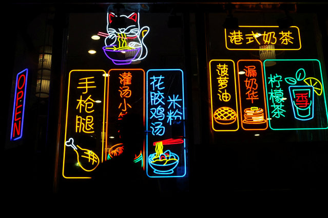 A man in silhouette walks by the JibeiChuan restaurant in the Chinatown neighborhood of Boston, Massachusetts, U.S., September 3, 2025. (Photo by Shannon Stapleton/Reuters)