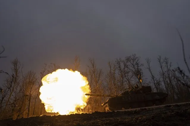 A Ukrainian tank towards fires towards Russian positions at the frontline near Bakhmut, Ukraine, Wednesday, March 8, 2023. (Photo by Evgeniy Maloletka/AP Photo)