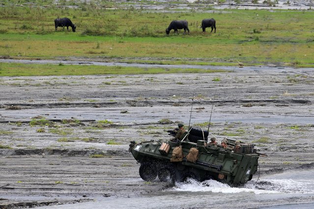 U.S. military forces aboard Light Armored Recon Vehicles (LARV) manoeuvre during the annual  Philippines-US live fire amphibious landing exercise (PHIBLEX) at Crow Valley in Capas, Tarlac province, north of Manila, Philippines October 10, 2016. (Photo by Romeo Ranoco/Reuters)