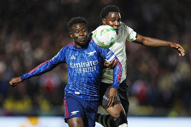 Arsenal's Bukayo Saka (left) and Port Vale's Jaheim Headley battle for the ball during the Carabao Cup third round match at Vale Park, Stoke-on-Trent, UK on Wednesday, September 24, 2025. (Photo by Peter Byrne/PA Wire)