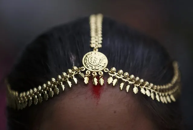 A traditional ornament is pictured on the head of a Tharu girl during a parade marking an Elephant Festival event at Sauraha in Chitwan, about 170 km (106 miles) south of Kathmandu December 26, 2014. (Photo by Navesh Chitrakar/Reuters)