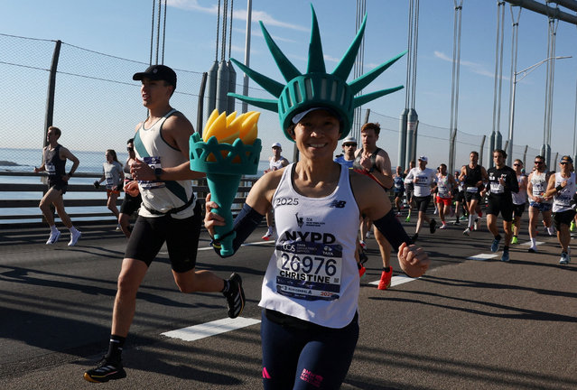 A runner dressed as the Statue of Liberty on the Verrazzano-Narrows Bridge during the New York City Marathon on November 2, 2025. (Photo by Brendan Mcdermid/Reuters)