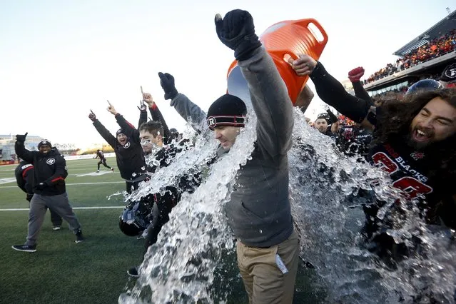 Ottawa Redblacks' head coach Rick Campbell has water poured on him during the final seconds of the CFL eastern final football game against the Hamilton Tiger-Cats in Ottawa, Canada November 22, 2015. (Photo by Chris Wattie/Reuters)