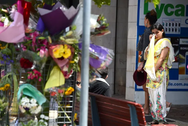 A woman reacts as she looks at a floral tribute for a bus driver that was murdered last Friday in Brisbane, Australia, October 30, 2016. (Photo by Dan Peled/Reuters/AAP)