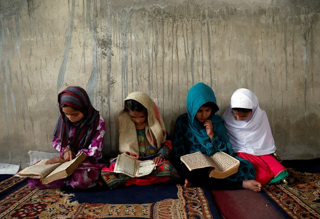 Afghan girls read the Koran in a madrasa, or religious school, during the Muslim holy month of Ramadan in Kabul, Afghanistan May 28, 2018. (Photo by Mohammad Ismail/Reuters)