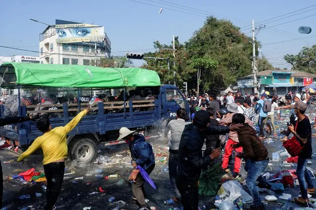 Demonstrators riot against police as they protest against the military coup in Mandalay, Myanmar, February 9, 2021. (Photo by Reuters/Stringer)