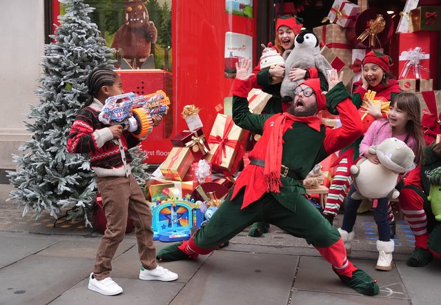 Elves and children play with toys outside Hamleys in London during the unveiling of their top toys for Christmas on Tuesday, October 1, 2024. (Photo by Jordan Pettitt/PA Images via Getty Images)