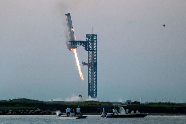 SpaceX’s Super Heavy rocket booster, which had just launched the uncrewed Starship spacecraft, successfully returns to the launch site near Boca Chica, Texas, on Sunday, October 13, 2024. The booster was caught midair with a pair of massive metal pincers that SpaceX calls “chopsticks”. (Photo by Sergio Flores/AFP Photo)