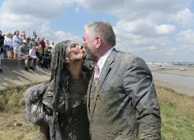 Matt and Dominique Sellors came straight from their wedding to take park in race in Essex, United Kingdom on April 24, 2022. The Maldon Mud race returns to Promenade Park in the Essex town after a two year absence due to Covid-19. The race is run on a 450 metre course across the River Blackmore and can only take place at low tide. This event originated in 1973, when a local man was challenged to don a tuxedo to serve a meal on the bank of the river. This later led to a race across the river where locals had to drink a pint from a waiting barrel of beer before racing back again. (Photo by Martin Dalton/EPA/EFE/Rex Features/Shutterstock)
