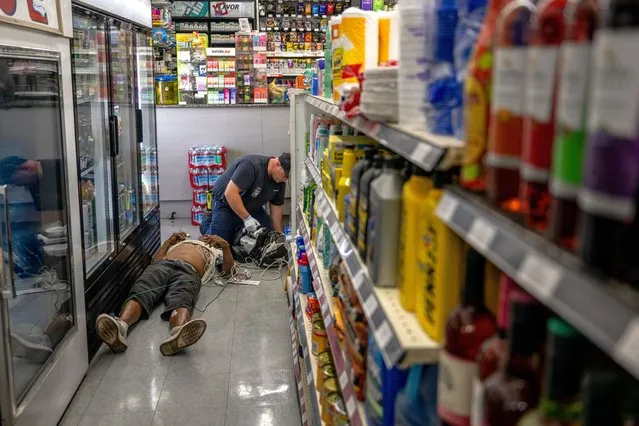 A person receives medical attention after collapsing in a convenience store on July 13, 2023 in Phoenix, Arizona. EMT was called after the person said they experienced hot flashes, dizziness, fatigue and chest pain. Today marks the Phoenix area's 14th consecutive day of temperatures exceeding 110 degrees Fahrenheit. Record-breaking temperatures continue soaring as prolonged heatwaves sweep across the Southwest. (Photo by Brandon Bell/Getty Images)