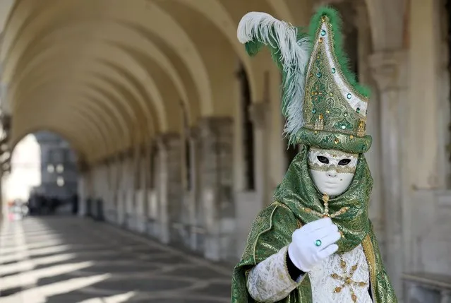 A masked reveller poses in Saint Mark square during carnival in Venice February 8, 2015. (Photo by Stefano Rellandini/Reuters)