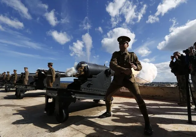 Malta Heritage Trust historical re-enactors, in World War One-era Royal Malta Artillery uniforms, fire the cannons in a general salute to mark the feast of Saint Paul's Shipwreck at the Upper Barrakka Saluting Battery in Valletta February 10, 2015. The Maltese trace their conversion to Christianity to Saint Paul's three-month stay on the island in 60AD, after he was shipwrecked on the island. (Photo by Darrin Zammit Lupi/Reuters)