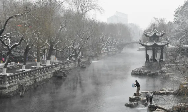 A man takes water from a moat as snow turns the city into a winter wonderland in Jinan, China on January 6, 2016. (Photo by Feng Jie/Xinhua Press/Corbis)