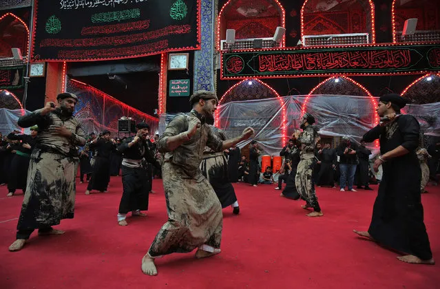 Shiite pilgrims take part in a ceremony during the ten-day mourning period leading up to Ashura, on September 19, 2018 in Iraq's holy city of Karbala. Ashura commemorates the death of Imam Hussein, grandson of the Muslim faith's prophet Mohammed, who was killed by the armies of his rival Yazid over the succession for the caliphate near Karbala in 680 AD. (Photo by Ahmad Al-Rubaye/AFP Photo)