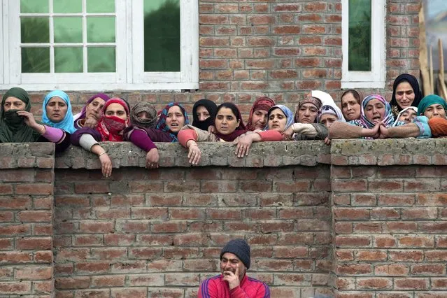 Kashmiri Muslims grieve as they watch the funeral procession  of Owais Bashir Malik in Srinagar, Indian controlled Kashmir, Thursday, January 14, 2016. Police fired warning shots and tear gas Thursday to disperse hundreds of protesters shouting anti-India slogans after the body of a college student with his throat slit was found in the Indian-controlled portion of Kashmir. (Photo by Dar Yasin/AP Photo)