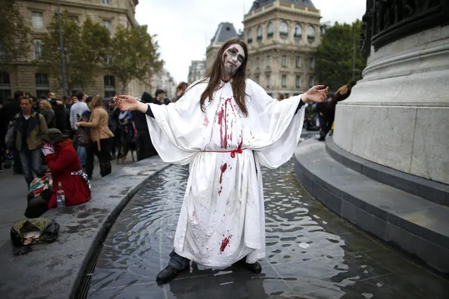 A man dressed as a zombie participates in a Zombie Walk procession in the streets of Paris October 12, 2013. (Photo by Benoit Tessier/Reuters)