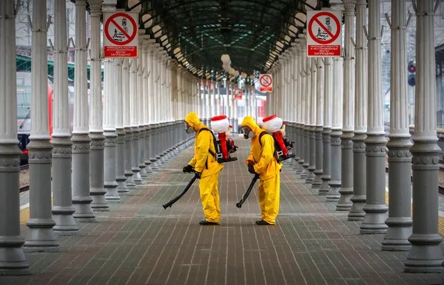 Russian Emergency Situations Ministry workers sanitise Belorussky railway station as part of the campaign to prevent the spread of the SARS-CoV-2 coronavirus which causes the COVID-19 disease in Moscow, Russia, 11 June 2020. For the first time since February, more than 12 thousand cases of COVID-19 have been identified in Russia. (Photo by Sergei Ilnitsky/EPA/EFE)