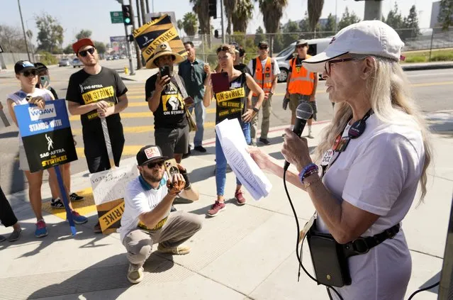 Actor Frances Fisher reads a poem by Screen Actors Guild member S.A. Griffin to picketers outside Netflix studios, Tuesday, October 17, 2023, in Los Angeles. (Photo by Chris Pizzello/AP Photo)