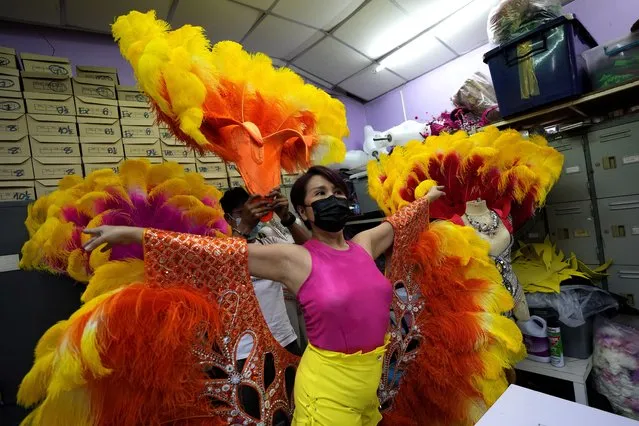 Costume manager Supat Kuntatun wears a new performance costume at the Phuket Simon Cabaret in Phuket, southern Thailand, Tuesday, June 29, 2021. (Photo by Sakchai Lalit/AP Photo)