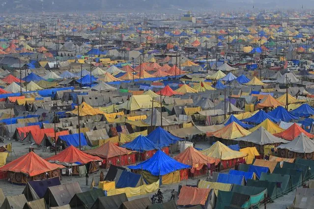 A general view of a giant tent city built for pilgrims attending the Magh Mela, a month-long Hindu festival, in Allahabad, India, January 31, 2016. The festival is an annual religious event held during the Hindu month of Magh, when thousands of Hindu devotees take a holy dip in the waters of the Sangam, the confluence of the rivers Ganges, Yamuna and Saraswati. (Photo by Jitendra Prakash/Reuters)