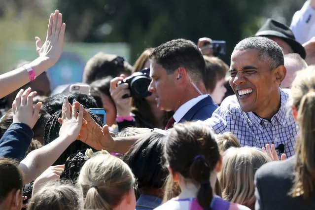 U.S. President Barack Obama high-fives with children after reading the storybook “Where the Wild Things Are” during the annual Easter Egg Roll at the White House in Washington April 6, 2015. (Photo by Jonathan Ernst/Reuters)